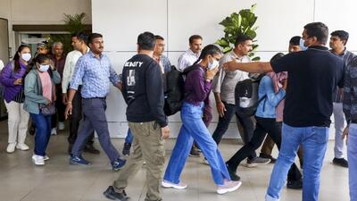 The immigrants deported from USA being escorted upon their arrival at the airport in Ahmedabad on Monday. (PTI) The immigrants deported from USA being escorted upon their arrival at the airport in Ahmedabad on Monday. (PTI)