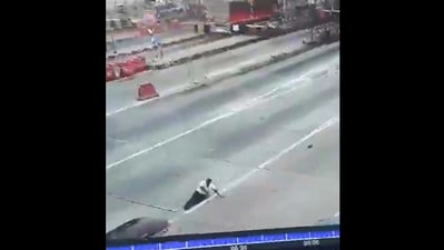 In the CCTV footage, the driver of the car can be seen grabbing the other man’s shirt. (X/@karnatakaportf) In the CCTV footage, the driver of the car can be seen grabbing the other man’s shirt. (X/@karnatakaportf)