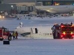 A Delta Airlines plane sits on its roof after crashing upon landing at Toronto Pearson Airport in Toronto, Ontario, on February 17, 2025. (Photo by Geoff Robins / AFP) A Delta Airlines plane sits on its roof after crashing upon landing at Toronto Pearson Airport in Toronto, Ontario, on February 17, 2025. (Photo by Geoff Robins / AFP)