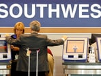 FILE PHOTO: A passenger waits at the Southwest Airlines ticket counter at Midway Airport in Chicago, Illinois July 24, 2008.