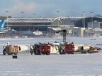 An aircraft from Delta Airlines sits upside down on the tarmac at Toronto Pearson International airport,. An aircraft from Delta Airlines sits upside down on the tarmac at Toronto Pearson International airport,.