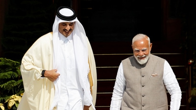 Emir of Qatar Sheikh Tamim bin Hamad Al Thani walks next to India's Prime Minister Narendra Modi on the day of their meeting at Hyderabad House in New Delhi. (REUTERS)