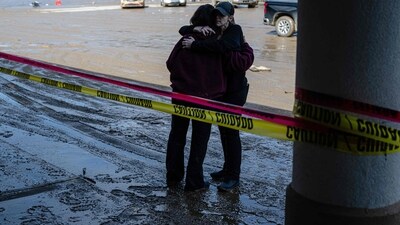 PIKEVILLE, KENTUCKY - FEBRUARY 17: Business owners hug at a strip mall following rain storms that caused flooding on February 17, 2025 in Pikeville, Kentucky. Severe winter storms brought torrential rains causing intense flooding in Kentucky and parts of Florida and Georgia. Jon Cherry/Getty Images/AFP (Photo by Jon Cherry / GETTY IMAGES NORTH AMERICA / Getty Images via AFP) (Getty Images via AFP) PIKEVILLE, KENTUCKY - FEBRUARY 17: Business owners hug at a strip mall following rain storms that caused flooding on February 17, 2025 in Pikeville, Kentucky. Severe winter storms brought torrential rains causing intense flooding in Kentucky and parts of Florida and Georgia. Jon Cherry/Getty Images/AFP (Photo by Jon Cherry / GETTY IMAGES NORTH AMERICA / Getty Images via AFP) (Getty Images via AFP)