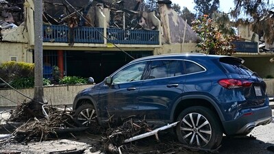 A stranded car is pictured next to a burned building near the Palisades Fire zone, in the aftermath of a storm in the Pacific Palisades neighborhood of Los Angeles, California, on February 14, 2025. A monster rainstorm was drenching southern California on February 13, 2025, with officials in Los Angeles readying for flooding and landslides in areas burned by last month's huge wildfires. Heavy rain was falling across a swath of the state, with as much as six inches (15 centimeters) expected in some places, forecasters from the National Weather Service (NWS) said. (Photo by AGUSTIN PAULLIER / AFP) (AFP) A stranded car is pictured next to a burned building near the Palisades Fire zone, in the aftermath of a storm in the Pacific Palisades neighborhood of Los Angeles, California, on February 14, 2025. A monster rainstorm was drenching southern California on February 13, 2025, with officials in Los Angeles readying for flooding and landslides in areas burned by last month's huge wildfires. Heavy rain was falling across a swath of the state, with as much as six inches (15 centimeters) expected in some places, forecasters from the National Weather Service (NWS) said. (Photo by AGUSTIN PAULLIER / AFP) (AFP)