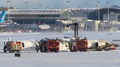 An aircraft from Delta Airlines sits upside down on the tarmac at Toronto Pearson International airport,. (AP) An aircraft from Delta Airlines sits upside down on the tarmac at Toronto Pearson International airport,. (AP)
