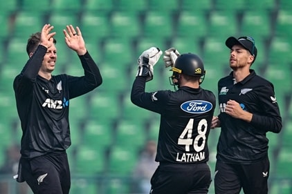 New Zealand's captain Mitchell Santner (R) and wicketkeeper Tom Latham (C) celebrate with Michael Bracewell. (AFP) New Zealand's captain Mitchell Santner (R) and wicketkeeper Tom Latham (C) celebrate with Michael Bracewell. (AFP)