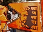 Chhatrapati Shivaji Maharaj jayanti: On the occasion of Chhatrapati Shivaji Maharaj Jayanti in Thane, Teen haat naka, Bhagava colored flags are being sold. A mother is seen showing the flag to her child, in Thane, in Mumbai, India, on, Tuesday, February -18, 2024.	