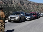 Cars queue as they seek to enter the southern Lebanese village of Kfar Kila.