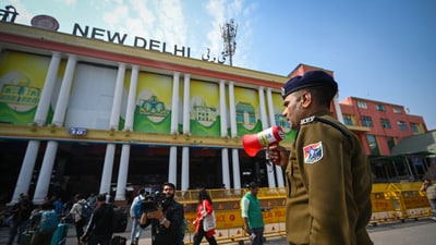 A Railway Police personnel doing announcements at the New Delhi Railway Station, days after the February 15 stampede which resulted in the death of 18 people.  (Photo by Sanchit Khanna/ Hindustan Times)
