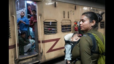New Delhi: A RPF official carrying her child manages a crowd of passengers at the New Delhi Railway Station, in New Delhi, Sunday, Feb. 16, 2025. At least 18 people were killed and more than a dozen injured in a stampede that broke out late Saturday night at the crowded railway station in the national capital. (PTI Photo/Kamal Kishore) (PTI02_16_2025_000323A) (PTI) New Delhi: A RPF official carrying her child manages a crowd of passengers at the New Delhi Railway Station, in New Delhi, Sunday, Feb. 16, 2025. At least 18 people were killed and more than a dozen injured in a stampede that broke out late Saturday night at the crowded railway station in the national capital. (PTI Photo/Kamal Kishore) (PTI02_16_2025_000323A) (PTI)