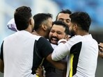 India's captain Rohit Sharma (C) celebrates with his teammates as he plays a game with a soccer ball during a practice session
