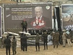 Hamas militants stand near coffins during the handover of deceased hostages Oded Lifschitz, Shiri Bibas and her two children Kfir and Ariel Bibas, seized during the deadly October 7, 2023 attack, to the Red Cross, as part of a ceasefire and hostages-prisoners swap deal between Hamas and Israel, in Khan Younis in the southern Gaza Strip, in this still image taken from a video February 20, 2025. 