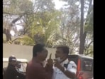 The video shows the heated altercation escalating as the driver hurls abuses at the traffic cop while holding a child in his arms.