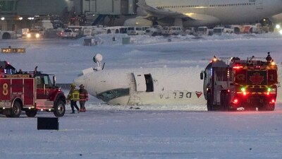 A Delta Airlines plane sits on its roof after crashing upon landing at Toronto Pearson Airport in Toronto, Ontario, on February 17, 2025. (Photo by Geoff Robins / AFP) (AFP) A Delta Airlines plane sits on its roof after crashing upon landing at Toronto Pearson Airport in Toronto, Ontario, on February 17, 2025. (Photo by Geoff Robins / AFP) (AFP)