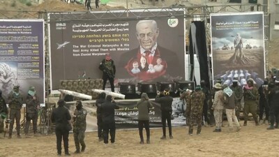 Hamas militants stand near coffins during the handover of deceased hostages Oded Lifschitz, Shiri Bibas and her two children Kfir and Ariel Bibas, seized during the deadly October 7, 2023 attack, to the Red Cross, as part of a ceasefire and hostages-prisoners swap deal between Hamas and Israel, in Khan Younis in the southern Gaza Strip, in this still image taken from a video February 20, 2025. (REUTERS)