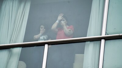 Migrants deported from the United States wave to the press from inside a hotel in Panama City (AP/Agustin Herrera) Migrants deported from the United States wave to the press from inside a hotel in Panama City (AP/Agustin Herrera)