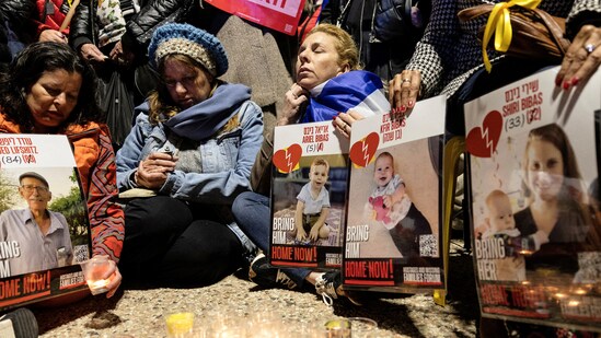 Israelis sit together as they light candles and mourn the deceased hostages Oded Lifschitz, Shiri Bibas and her two children, Kfir and Ariel Bibas, seized during the deadly October 7, 2023 attack by Hamas, on the day their bodies were handed over under the terms of a ceasefire between Hamas and Israel, in Tel Aviv, Israel February 20, 2025. (REUTERS/Itay Cohen     TPX IMAGES OF THE DAY) (REUTERS)