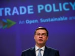 European Commissioner for Trade Valdis Dombrovskis, looks on.
