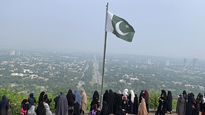 A Pakistani flag flies on a lookout as women take in the view of Islamabad, Pakistan, (AP Photo/Image used only for representation)