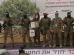 Omer Shem Tov, Eliya Cohen and Omer Wenkert, hostages held in Gaza since the deadly October 7, 2023 attack, are released as part of a ceasefire and a hostages-prisoners swap deal between Hamas and Israel, in Nuseirat, central Gaza Strip on February 22.