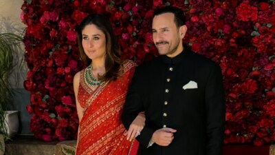Kareena Kapoor looked stunning in an orange saree paired with a sleeveless blouse. She completed her look with statement jewellery and carried a matching potli bag. Saif Ali Khan looked classy as he complemented her in a black sherwani with gold buttons and a white pocket square. Kareena Kapoor looked stunning in an orange saree paired with a sleeveless blouse. She completed her look with statement jewellery and carried a matching potli bag. Saif Ali Khan looked classy as he complemented her in a black sherwani with gold buttons and a white pocket square.