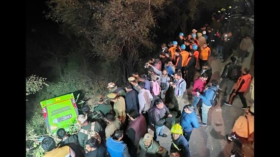 People gather near the site where a bus fell into a gorge at Manda area in Jammu district on Saturday. (PTI)