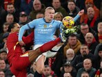 Liverpool's Virgil van Dijk in action with Manchester City's Erling Haaland.