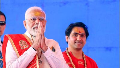 Prime Minister Narendra Modi greets people during the foundation stone laying ceremony of Bageshwar Dham Medical and Science Research Institute, in Madhya Pradesh’s Chhatarpur on Sunday. (DPR PMO) Prime Minister Narendra Modi greets people during the foundation stone laying ceremony of Bageshwar Dham Medical and Science Research Institute, in Madhya Pradesh’s Chhatarpur on Sunday. (DPR PMO)