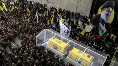 Mourners walk during the funeral procession with the vehicle carrying the coffins of Hezbollah's slain leaders Hassan Nasrallah and Hashem Safieddine from the Camille Chamoun Sports City Stadium towards the burial place on the outskirts of Beirut on February 23, 2025. (AFP) Mourners walk during the funeral procession with the vehicle carrying the coffins of Hezbollah's slain leaders Hassan Nasrallah and Hashem Safieddine from the Camille Chamoun Sports City Stadium towards the burial place on the outskirts of Beirut on February 23, 2025. (AFP)