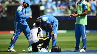 A team member checks the leg of India's Mohammed Shami (C) as his team captain Rohit Sharma watches during the ICC Champions Trophy ODI match between India and Pakistan. (AFP) A team member checks the leg of India's Mohammed Shami (C) as his team captain Rohit Sharma watches during the ICC Champions Trophy ODI match between India and Pakistan. (AFP)