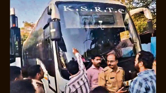 Shiv Sena (UBT) workers deface buses bearing Karnataka number plates in Pune on Sunday. (PTI)