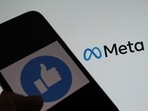 This illustration photo taken in Los Angeles on October 28, 2021, shows a person using Facebook on a smartphone in front of a computer screen showing the META logo. This illustration photo taken in Los Angeles on October 28, 2021, shows a person using Facebook on a smartphone in front of a computer screen showing the META logo.