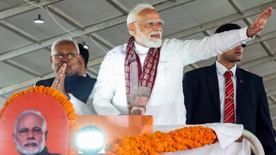 Prime Minister Narendra Modi waves to the gathering on his arrival to release the 19th instalment of the PM Kisan Samman Nidhi Yojana, in Bhagalpur on Monday. Bihar Chief Minister Nitish Kumar also present. (DPR PMO/ANI)