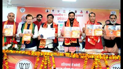 Haryana CM Nayab Singh Saini releasing the BJP's manifesto for local bodies’ elections-2025 in Rohtak on Monday. State BJP president Mohan Lal Badoli, cabinet minister Vipul Goyal, minister Arvind Sharma and other senior leaders were present on the occasion. (Manoj Dhaka/HindustanTimes)