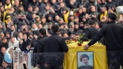 A trailer carrying the coffins containing the bodies of Hezbollah's former leader Hassan Nasrallah and his cousin and successor Hashem Safieddine drives through the crowd at the beginning of a funeral procession in the Sports City Stadium in Beirut, Lebanon, Sunday. (AP) A trailer carrying the coffins containing the bodies of Hezbollah's former leader Hassan Nasrallah and his cousin and successor Hashem Safieddine drives through the crowd at the beginning of a funeral procession in the Sports City Stadium in Beirut, Lebanon, Sunday. (AP)