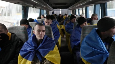 Ukrainian citizens wrapped in the Ukrainian national flag as they return from Russian captivity during a prisoner exchange, at an undisclosed location in Ukraine. (AFP) Ukrainian citizens wrapped in the Ukrainian national flag as they return from Russian captivity during a prisoner exchange, at an undisclosed location in Ukraine. (AFP)