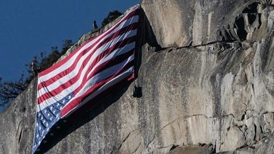 National park employees hoist an American flag upside-down on Yosemite National Park's summit El Capitan on Saturday. (Instagram / @voteinorout)