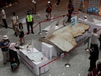 Visitors looking at the wreckage of an aircraft, believed to be from the missing Malaysia Airlines flight MH370, during the 10th anniversary event of its disappearance.