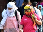People cover themselves with scarf to protect from heat at Vashi in Navi Mumbai, India, on Monday, February 24, 2025.
