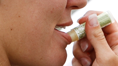 A woman applies lip balm. (AP) A woman applies lip balm. (AP)
