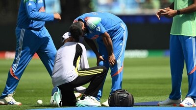 A team member checks the leg of India's Mohammed Shami (C) as his team captain Rohit Sharma (L) and teammate Arshdeep Singh (R) (AFP) A team member checks the leg of India's Mohammed Shami (C) as his team captain Rohit Sharma (L) and teammate Arshdeep Singh (R) (AFP)