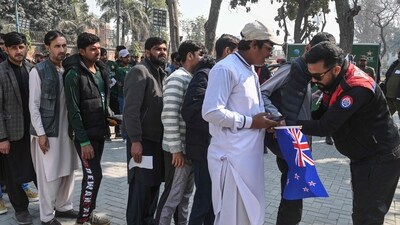 People stand in queues as security personnel frisk them at the entrance of the Gaddafi Stadium in Lahore (AFP) People stand in queues as security personnel frisk them at the entrance of the Gaddafi Stadium in Lahore (AFP)