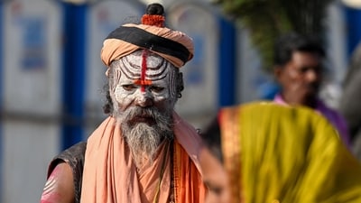 A holy man walks past a pilgrim near Sangam, the confluence of Ganges, Yamuna and mythical Saraswati rivers, on the eve of Maha Shivaratri during the Maha Kumbh Mela festival in Prayagraj on February 25, 2025. (AFP) A holy man walks past a pilgrim near Sangam, the confluence of Ganges, Yamuna and mythical Saraswati rivers, on the eve of Maha Shivaratri during the Maha Kumbh Mela festival in Prayagraj on February 25, 2025. (AFP)