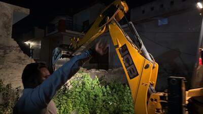 Punjab Police demolishing the house of a drug smuggler at Talwandi village near Ladhowal in Ludhiana district on Monday night. (HT Photo)