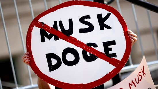 A demonstrator holds a sign during a rally to protest President Donald Trump and Elon Musk policies Feb. 17, 2025, in Los Angeles. (AP)