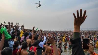 A helicopter showers flower petals on pilgrims during the Maha Kumbh Mela festival in Prayagraj on February 26, 2025. (Punit Paranjpe/AFP) A helicopter showers flower petals on pilgrims during the Maha Kumbh Mela festival in Prayagraj on February 26, 2025. (Punit Paranjpe/AFP)
