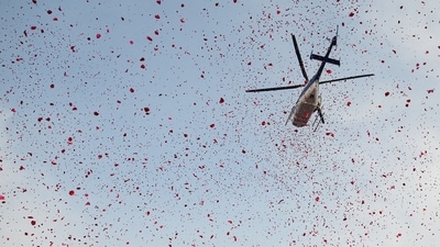 A helicopter showers flower petals on pilgrims taking holy dip at Sangam, the confluence of Ganges, Yamuna and mythical Saraswati rivers, on the occasion of Maha Shivaratri during the Maha Kumbh Mela festival in Prayagraj. (Punit Paranjpe/AFP) A helicopter showers flower petals on pilgrims taking holy dip at Sangam, the confluence of Ganges, Yamuna and mythical Saraswati rivers, on the occasion of Maha Shivaratri during the Maha Kumbh Mela festival in Prayagraj. (Punit Paranjpe/AFP)