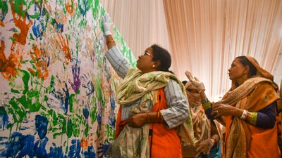 A devotee puts her handprints on a wall in the Ganga Pandal during the ongoing Maha Kumbh Mela 2025, in Prayagraj. Prayagraj Mela Authority made an attempt to make the longest hand-printing painting on an 80-feet-long and 5-feet-wide wall in the Ganga Pandal at the Maha Kumbh Mela. (PTI) A devotee puts her handprints on a wall in the Ganga Pandal during the ongoing Maha Kumbh Mela 2025, in Prayagraj. Prayagraj Mela Authority made an attempt to make the longest hand-printing painting on an 80-feet-long and 5-feet-wide wall in the Ganga Pandal at the Maha Kumbh Mela. (PTI)