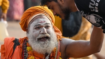 A sadhu speaks with a pilgrim at Sangam on the occasion of Maha Shivaratri during the Maha Kumbh Mela festival in Prayagraj on February 26, 2025. (Punit Paranjpe/AFP) A sadhu speaks with a pilgrim at Sangam on the occasion of Maha Shivaratri during the Maha Kumbh Mela festival in Prayagraj on February 26, 2025. (Punit Paranjpe/AFP)