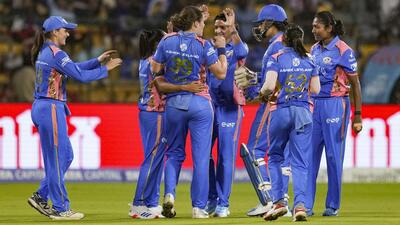 Nat Sciver-Brunt celebrates with Mumbai Indians teammates after taking the wicket of UP Warriorz batter Kiran Navgire. (PTI)